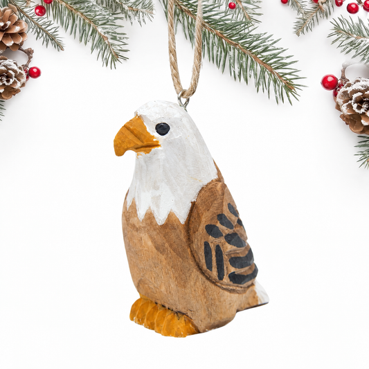 Bald Eagle hand-carved wooden ornament by Selsela, on a plain background