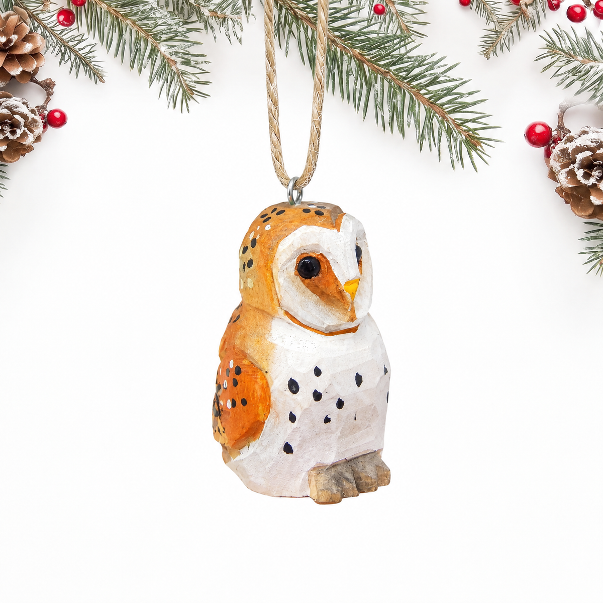 Barn Owl hand-carved wooden ornament by Selsela, on a plain background