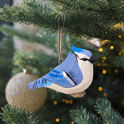 Blue Jay hand-carved wooden ornament by Selsela, hanging on a Christmas tree