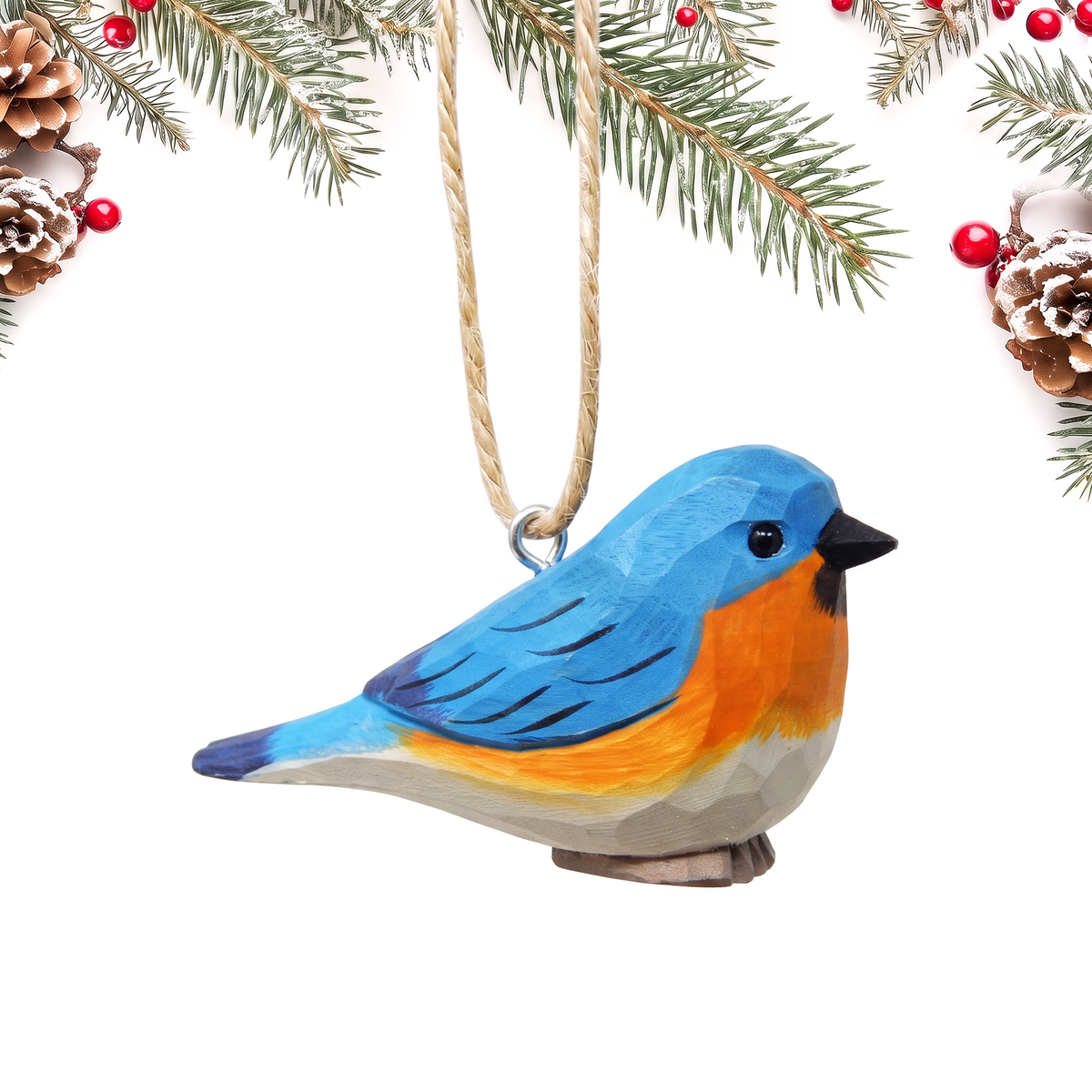 Eastern Bluebird hand-carved wooden ornament by Selsela, on a plain background