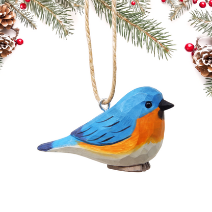Eastern Bluebird hand-carved wooden ornament by Selsela, on a plain background