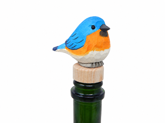 Eastern Bluebird hand-carved wooden wine stopper by Selsela, on a plain background