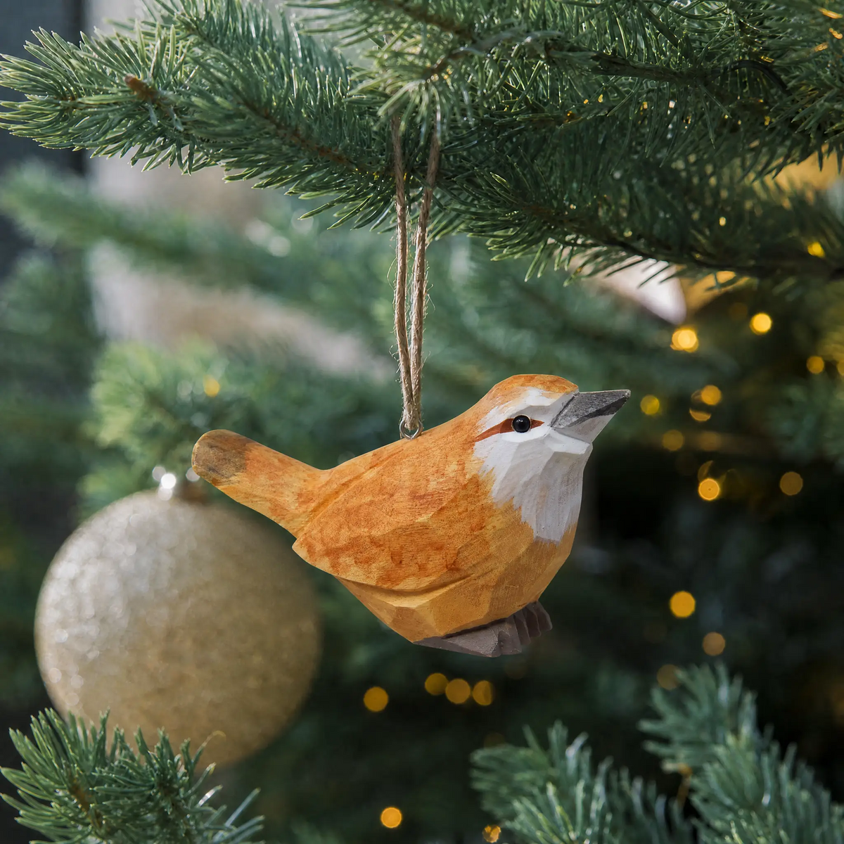Carolina Wren hand-carved wooden ornament by Selsela, hanging on a Christmas tree