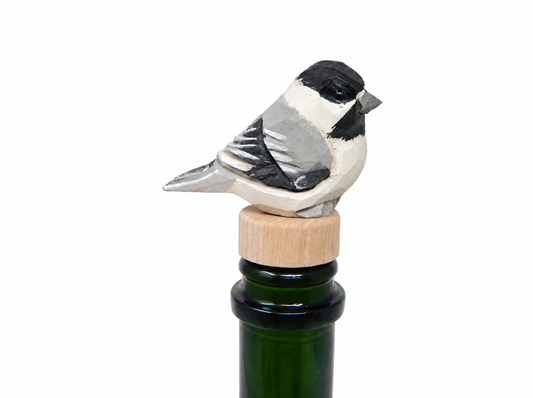 Chickadee hand-carved wooden wine stopper by Selsela, on a plain background