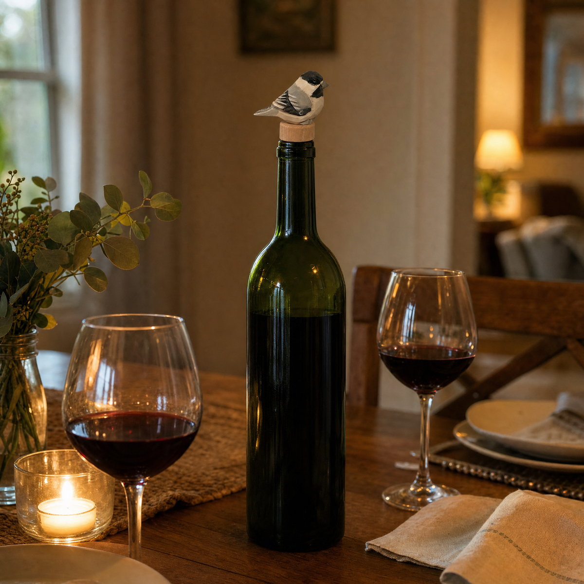 Chickadee hand-carved wooden wine stopper by Selsela, in a styled scene