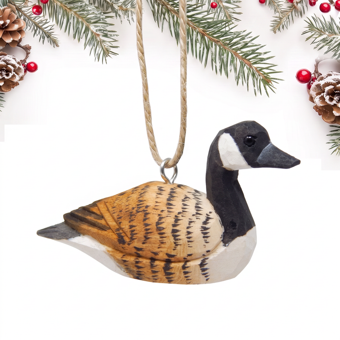Canada Goose hand-carved wooden ornament by Selsela, on a plain background