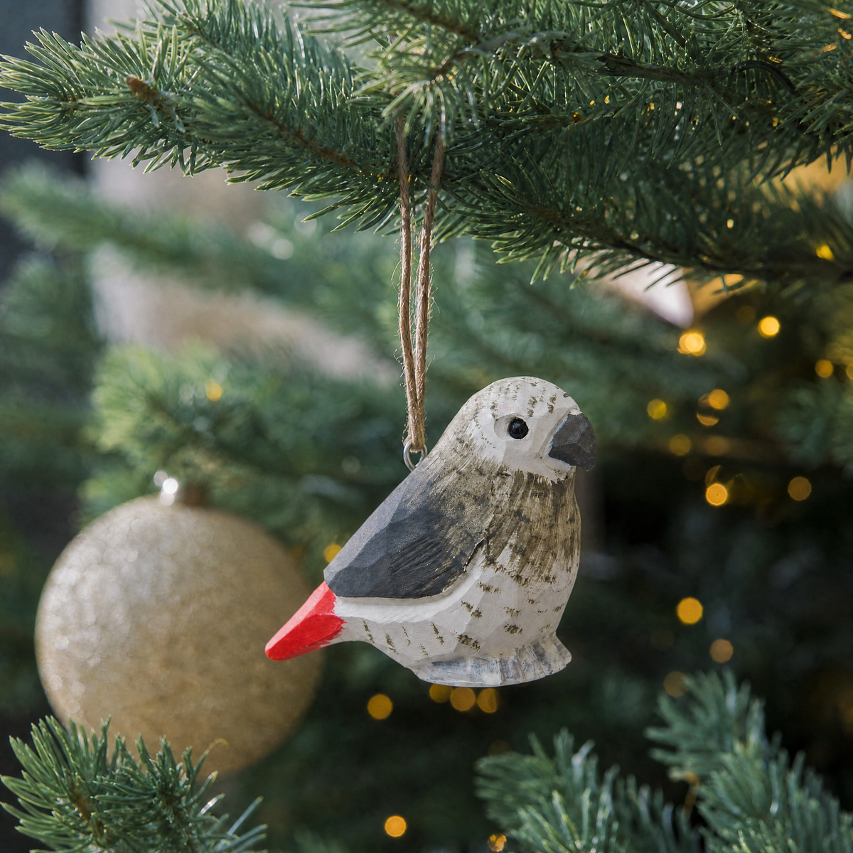 Grey Parrot hand-carved wooden ornament by Selsela, hanging on a Christmas tree