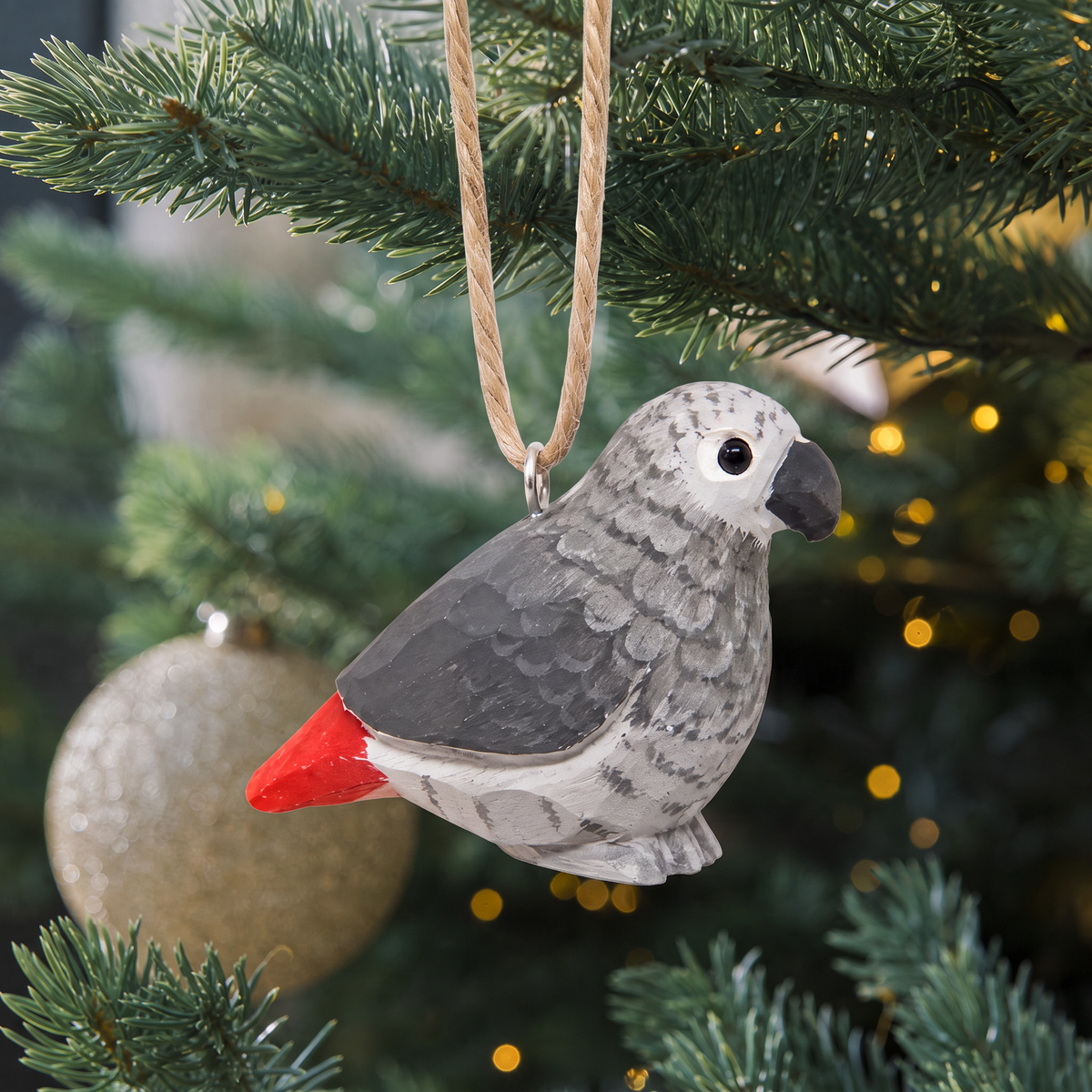 Grey Parrot hand-carved wooden ornament by Selsela, hanging on a Christmas tree