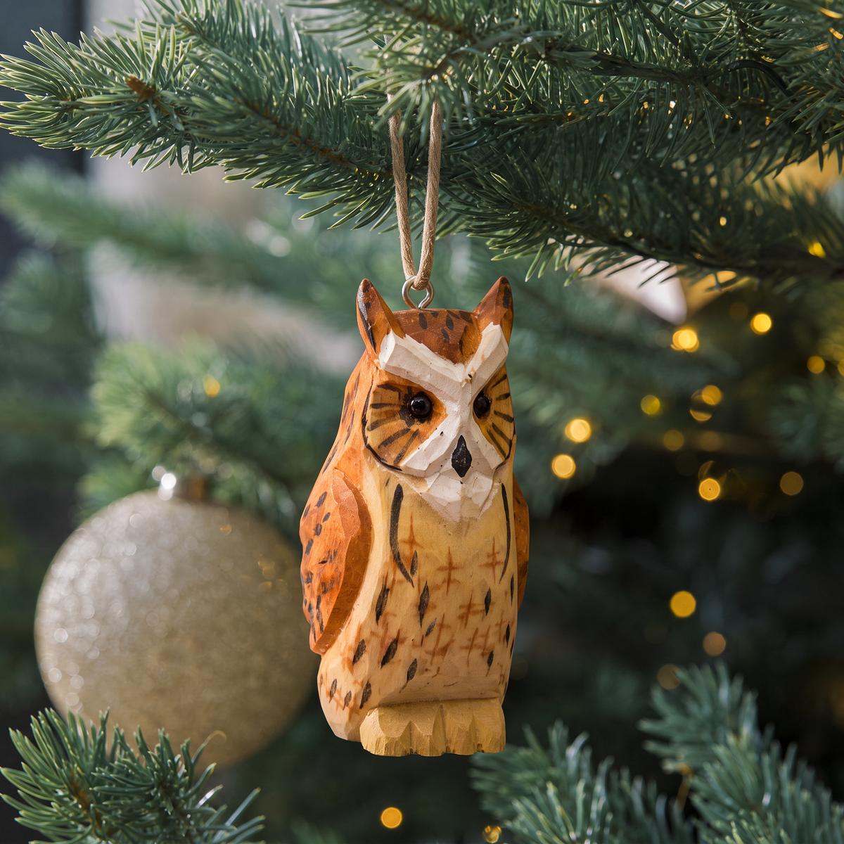 Great Horned Owl hand-carved wooden ornament by Selsela, hanging on a Christmas tree