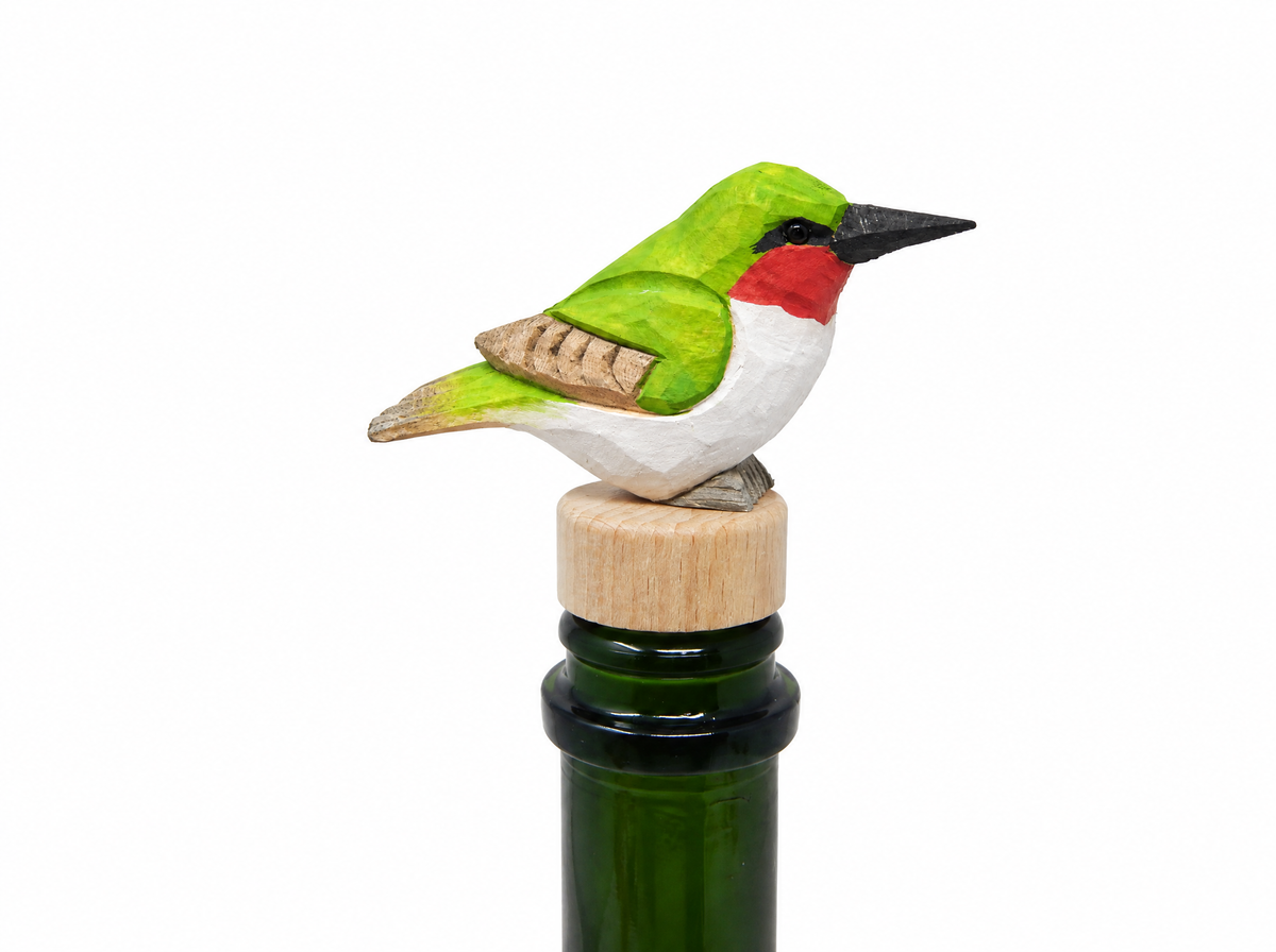 Hummingbird hand-carved wooden wine stopper by Selsela, on a plain background