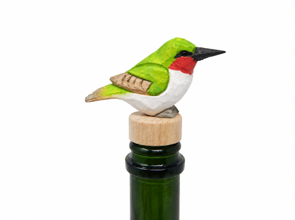 Hummingbird hand-carved wooden wine stopper by Selsela, on a plain background
