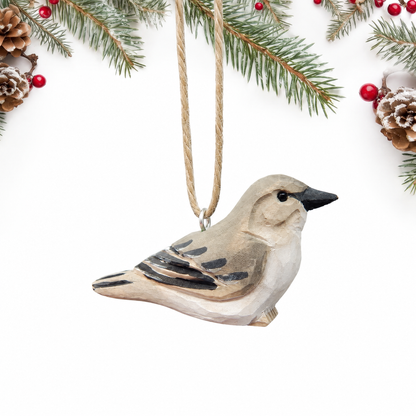 Northern Mockingbird hand-carved wooden ornament by Selsela, on a plain background