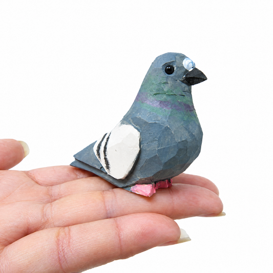 Pigeon hand-carved wooden figurine by Selsela, on a plain background