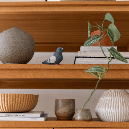 Pigeon hand-carved wooden figurine by Selsela, styled in a home setting