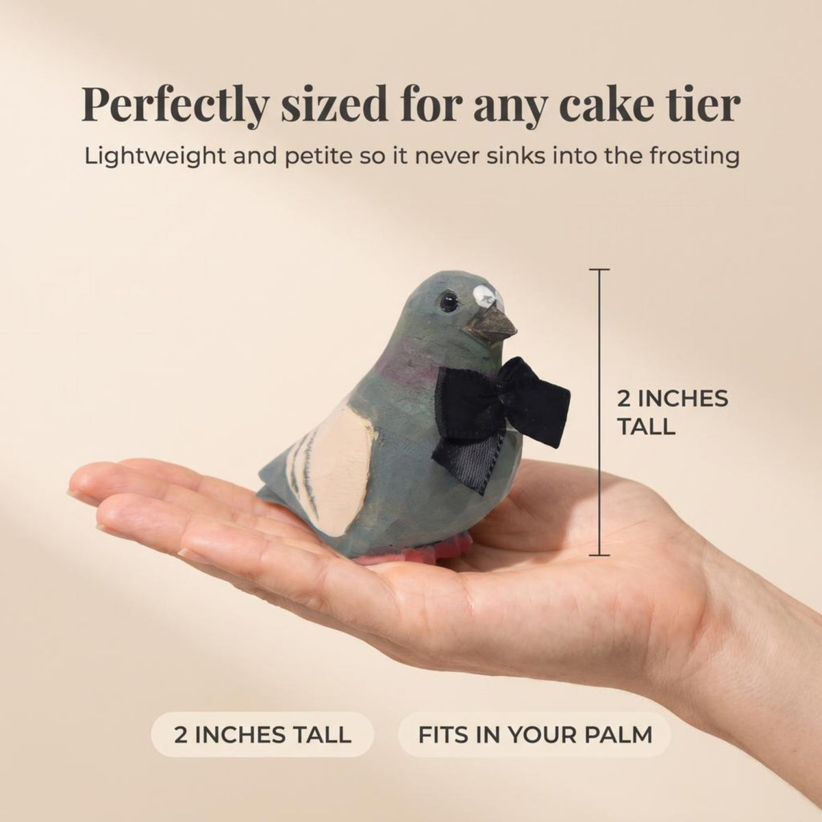 Pigeon hand-carved wooden cake topper by Selsela, bride and groom pair on a wedding cake