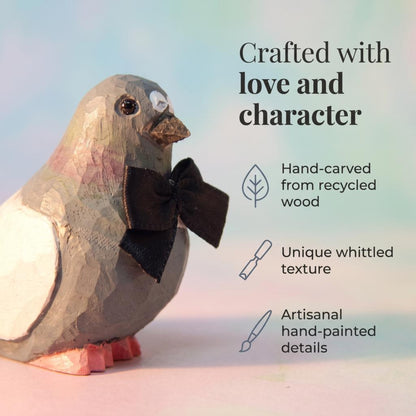 Pigeon hand-carved wooden cake topper by Selsela, bride and groom pair on a wedding cake