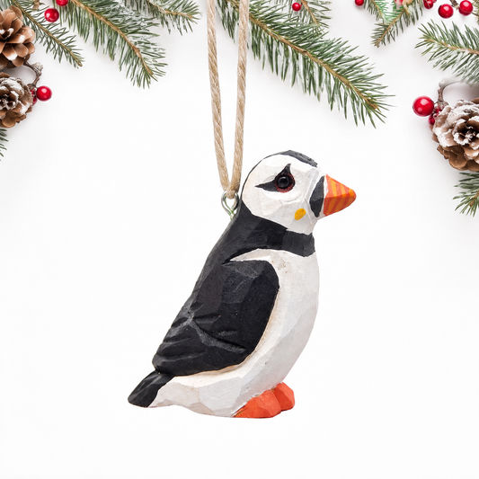 Puffin hand-carved wooden ornament by Selsela, on a plain background