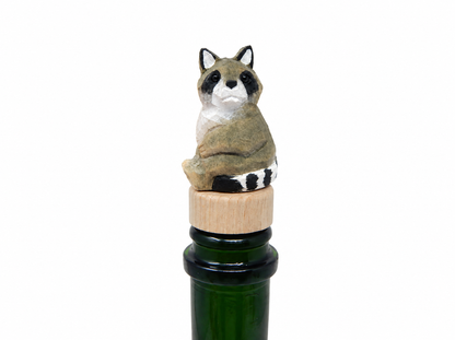 Raccoon hand-carved wooden wine stopper by Selsela, on a plain background