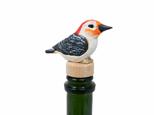Red-Bellied Woodpecker hand-carved wooden wine stopper by Selsela, on a plain background
