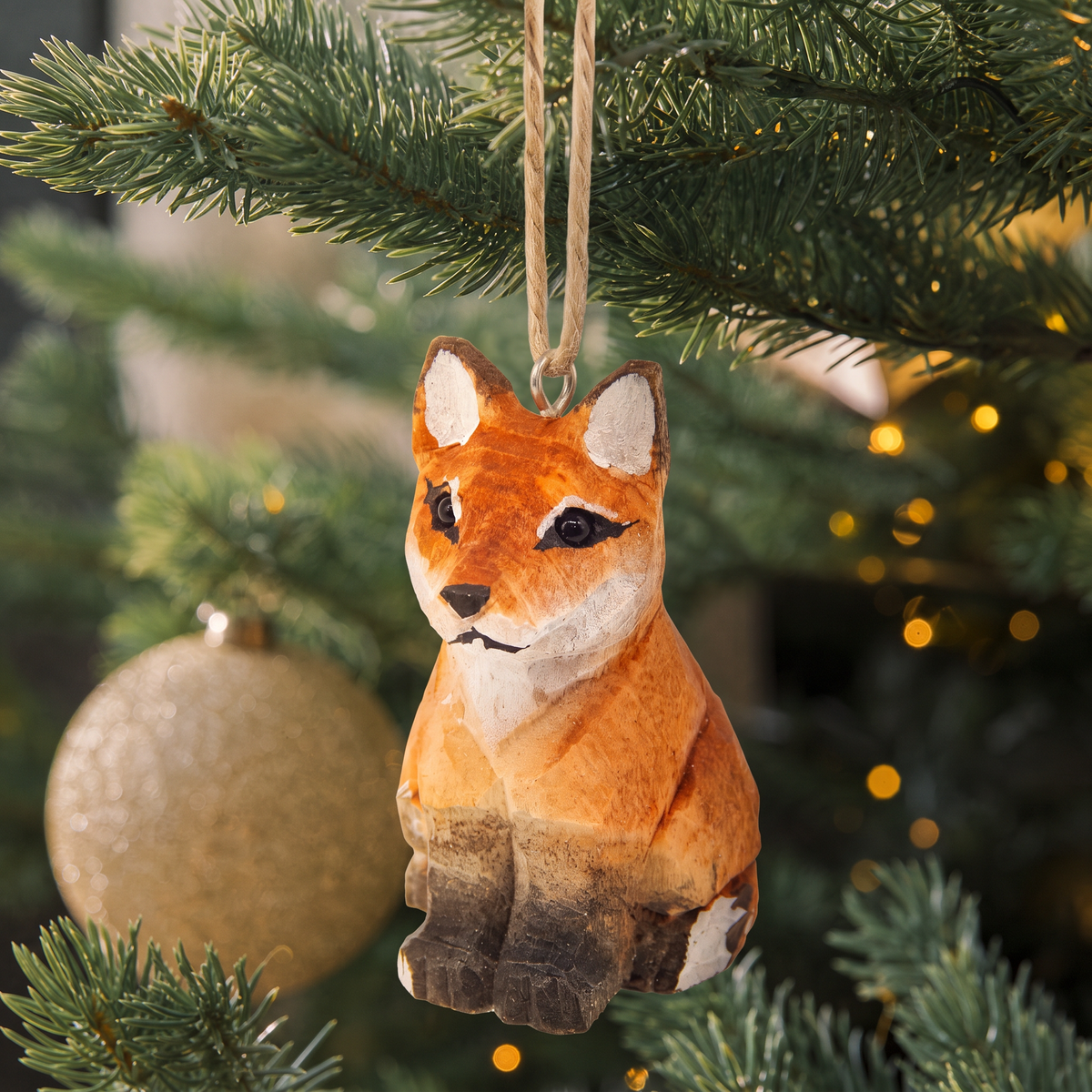 Red Fox hand-carved wooden ornament by Selsela, hanging on a Christmas tree