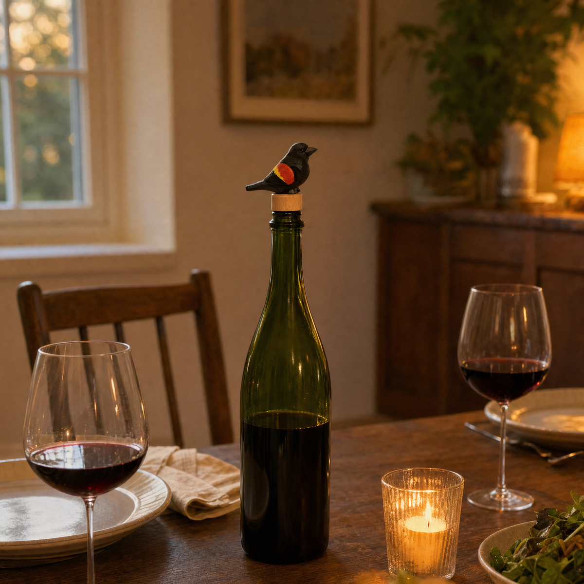 Red-Winged Blackbird hand-carved wooden wine stopper by Selsela, in a styled scene
