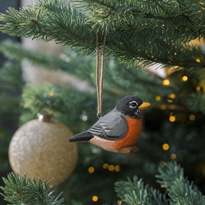 American Robin hand-carved wooden ornament by Selsela, hanging on a Christmas tree